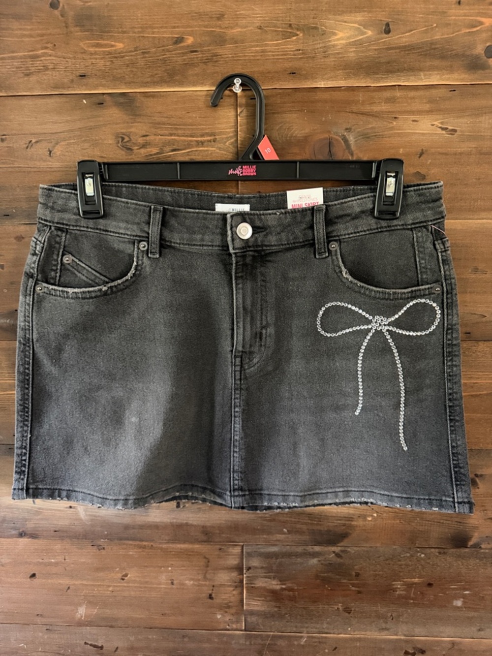 Millie Bobby Brown Black Denim Mini Skirt with rhinestone Bow Detail